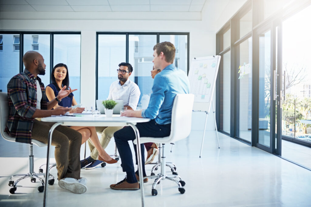 Shot of a group of young businesspeople discussing ideas with each other during a meeting in a modern office.